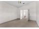 Neutral bedroom featuring a ceiling fan, carpet flooring, and an open doorway at 5660 Sandpipers Dr, Lakeland, FL 33809