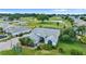 Aerial view of a gray roof house with well-maintained landscaping and a golf course view at 5660 Sandpipers Dr, Lakeland, FL 33809