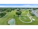 Expansive green golf course featuring gentle slopes and a peaceful pond at 5660 Sandpipers Dr, Lakeland, FL 33809