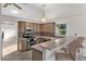 A bright kitchen showcases neutral cabinetry, a breakfast bar with seating, and stainless steel appliances at 5660 Sandpipers Dr, Lakeland, FL 33809