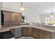 A sunny kitchen features stone countertops, stainless steel appliances, and a view of the lush backyard at 5660 Sandpipers Dr, Lakeland, FL 33809