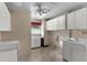 Well-lit laundry room equipped with white cabinets, sink, and tile flooring at 5660 Sandpipers Dr, Lakeland, FL 33809