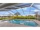 Enclosed pool overlooking a beautifully landscaped golf course and lake at 5660 Sandpipers Dr, Lakeland, FL 33809