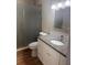 Bathroom featuring updated vanity, stone countertop, and walk-in shower at 200 El Camino Dr # 411, Winter Haven, FL 33884