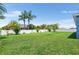 Expansive backyard features a well-kept lawn surrounded by a privacy fence and lush trees at 192 Viola Dr, Auburndale, FL 33823