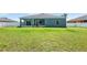 A spacious backyard features lush green grass and a covered screened lanai at 192 Viola Dr, Auburndale, FL 33823