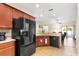 Modern kitchen with stainless steel appliances and granite countertops, open to a bright living area at 192 Viola Dr, Auburndale, FL 33823