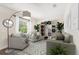 Bright staged living room with modern décor featuring neutral tones, large windows, and a stylish bookshelf at 192 Viola Dr, Auburndale, FL 33823