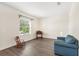 Cozy living room showcases laminate floors, a blue sofa and lots of natural light at 192 Viola Dr, Auburndale, FL 33823