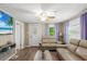 Cozy living room featuring light beige sofas and a large TV at 954 Reynolds Rd, Lakeland, FL 33801