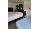 Shared bedroom featuring two beds, closet space, and a TV for relaxed living at 2031 Poe St, Lakeland, FL 33801