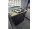 A dark cabinet with granite top and portable hotplate on top at 2031 Poe St, Lakeland, FL 33801