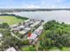 Aerial view of property near a lake with lush landscaping and mature trees at 2200 Starboard, Winter Haven, FL 33881