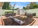 Private backyard featuring a fire pit, outdoor dining set, lounge chairs, and a storage shed at 2200 Starboard, Winter Haven, FL 33881