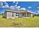 Backyard featuring a covered patio and lush green lawn at 4039 Tullamore Ln, Auburndale, FL 33823