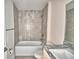 Bathroom with tiled walls, a white sink, and a full sized mirror at 4039 Tullamore Ln, Auburndale, FL 33823