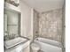 Bathroom features a shower and tub with tiled walls and a granite countertop sink at 4039 Tullamore Ln, Auburndale, FL 33823