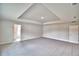 Expansive bedroom featuring soft carpet flooring, a tray ceiling, and ample natural light at 4039 Tullamore Ln, Auburndale, FL 33823