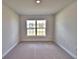 This bedroom features a neutral carpet and large window at 4039 Tullamore Ln, Auburndale, FL 33823