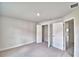 Bedroom featuring carpet, neutral walls, an open closet, and a door at 4039 Tullamore Ln, Auburndale, FL 33823