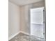 A bright bedroom with neutral walls and floors, featuring a door leading to another room at 4039 Tullamore Ln, Auburndale, FL 33823
