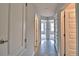 Bright hallway with tiled floor, a series of doorways, and neutral-colored walls at 4039 Tullamore Ln, Auburndale, FL 33823