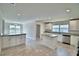 Modern kitchen with stainless appliances, white cabinets, and granite countertops at 4039 Tullamore Ln, Auburndale, FL 33823