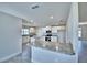 Modern kitchen features white cabinets, stainless appliances, granite countertops, and island with bar seating at 4039 Tullamore Ln, Auburndale, FL 33823