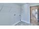 Simple laundry room featuring utility connections and a storage shelf at 4039 Tullamore Ln, Auburndale, FL 33823