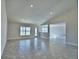 Bright, spacious living area with neutral color scheme, recessed lights, and sliding glass door at 4039 Tullamore Ln, Auburndale, FL 33823