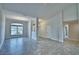 Bright open-concept living room boasts tile floors, neutral walls, and large windows for ample natural light at 4039 Tullamore Ln, Auburndale, FL 33823