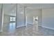 Open-concept living area featuring tile floors, bright walls, and seamless flow into kitchen area at 4039 Tullamore Ln, Auburndale, FL 33823