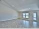 Open living room with tile flooring, recessed lighting, and a bright window at 4039 Tullamore Ln, Auburndale, FL 33823