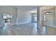 Open-concept living room featuring tile floors, neutral color walls, and a view into the modern kitchen at 4039 Tullamore Ln, Auburndale, FL 33823