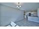 Open-concept design blending living and kitchen areas, highlighted by modern chandelier lighting at 4039 Tullamore Ln, Auburndale, FL 33823