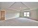 Large main bedroom featuring a tray ceiling, neutral carpet, and natural light at 4039 Tullamore Ln, Auburndale, FL 33823