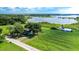 Aerial view of house and expansive lakefront lot with lush greenery at 420 W Gates Ave, Lake Hamilton, FL 33851