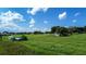 Aerial view of a rural property with lush green fields and outbuildings at 420 W Gates Ave, Lake Hamilton, FL 33851