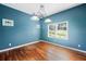 Dining room with hardwood floors, blue walls, and a window seat at 420 W Gates Ave, Lake Hamilton, FL 33851