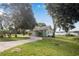 House exterior showcasing a light-blue home with mature trees and a long driveway at 420 W Gates Ave, Lake Hamilton, FL 33851