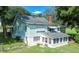 Light green house with sunroom and screened porch, needs some TLC at 420 W Gates Ave, Lake Hamilton, FL 33851