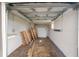 Unfinished garage with concrete floor and storage at 420 W Gates Ave, Lake Hamilton, FL 33851