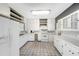 Bright kitchen featuring white cabinets and appliances, and tile floors at 420 W Gates Ave, Lake Hamilton, FL 33851