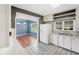 Kitchen with white cabinets, tile floors, and a view into a dining area at 420 W Gates Ave, Lake Hamilton, FL 33851