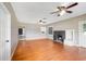 Spacious living room with hardwood floors, fireplace, and two ceiling fans at 420 W Gates Ave, Lake Hamilton, FL 33851
