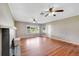 Living room featuring hardwood floors, a fireplace, and ceiling fans at 420 W Gates Ave, Lake Hamilton, FL 33851