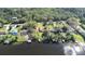 Aerial view of a waterfront neighborhood featuring private docks and lush landscaping at 9650 W Lake Marion Rd, Haines City, FL 33844