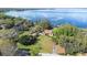 Beautiful aerial of the house with lake view and mature trees at 9650 W Lake Marion Rd, Haines City, FL 33844