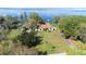Aerial view of a lakefront property with a manicured lawn and private lake access at 9650 W Lake Marion Rd, Haines City, FL 33844