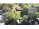 Aerial view of a waterfront home with a private dock and mature trees at 9650 W Lake Marion Rd, Haines City, FL 33844